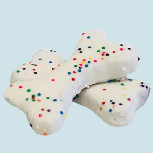 Homemade dog treats shaped like bones with colorful sprinkles